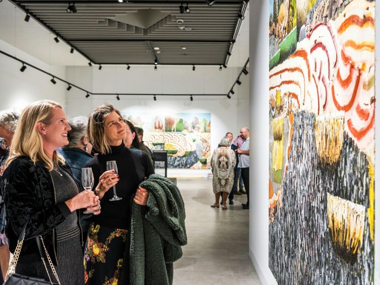 Visitors looking at a Guido Maestri painting at Mudgee Arts Precinct