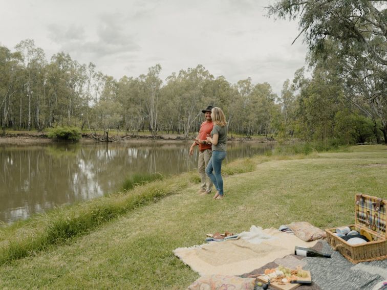 Couple picnicking on the banks of the Murray River at Lions Park Howlong