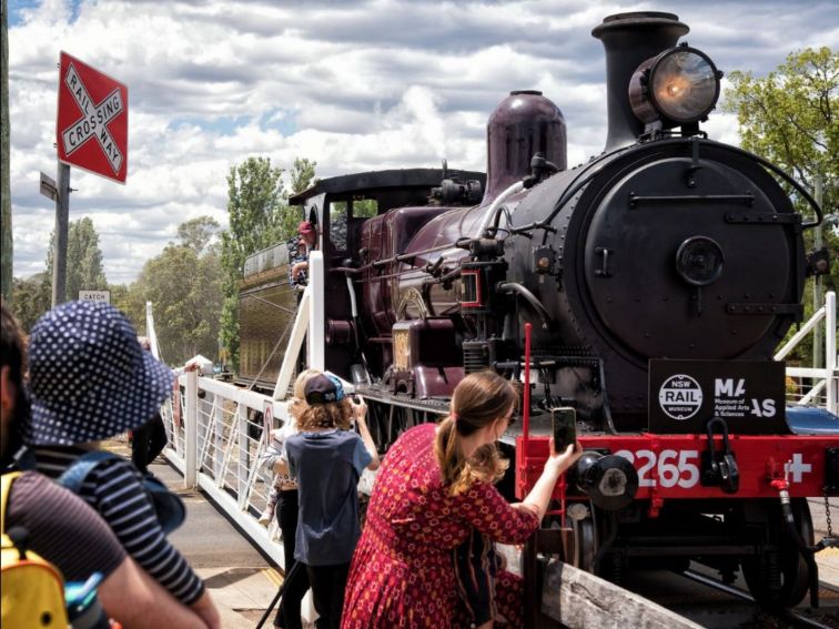 Locomotive steam train arriving into train station