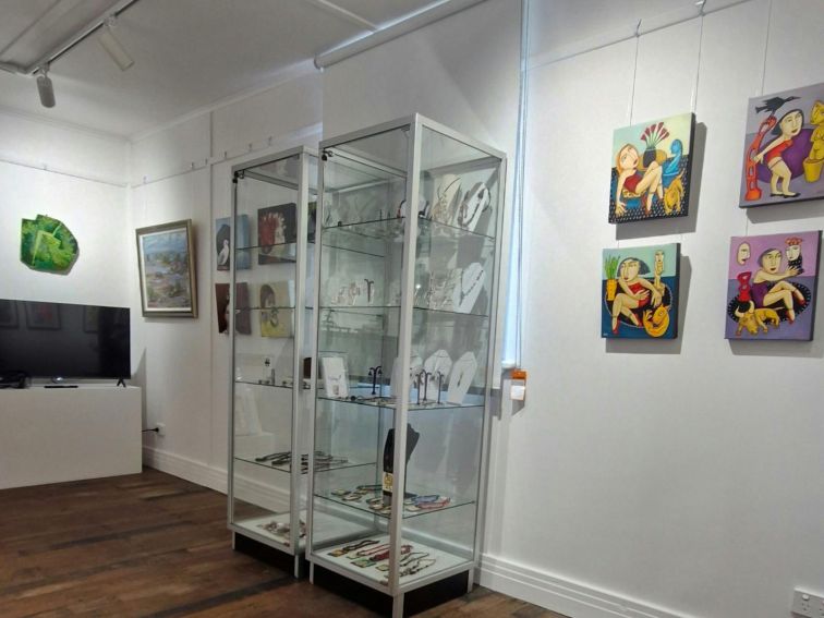 Gallery room showing jewellery cases, paintings and video.