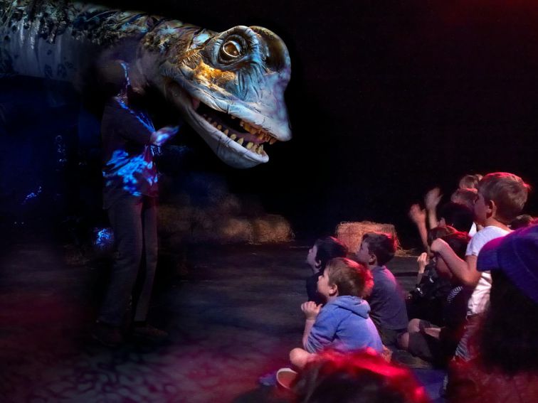 Dinosaur puppet infront of group of children