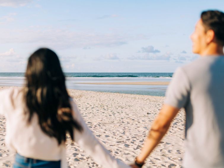 Couple enjoying a visit to North Belongil Beach, Byron Bay