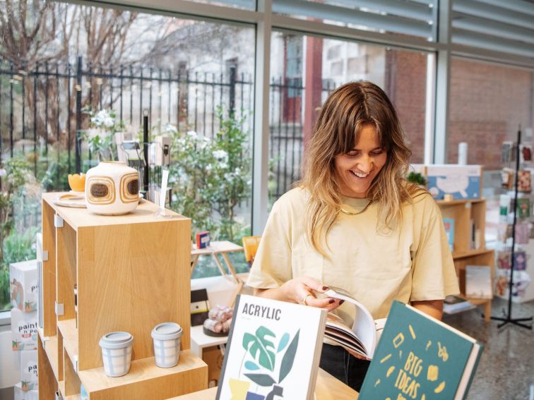 Woman browsing through books in store