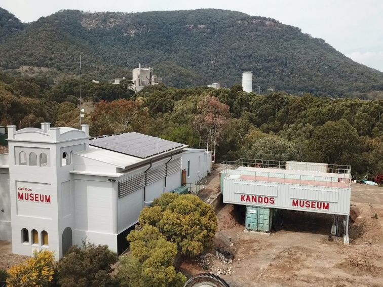 Drone shot of museum with works in the background