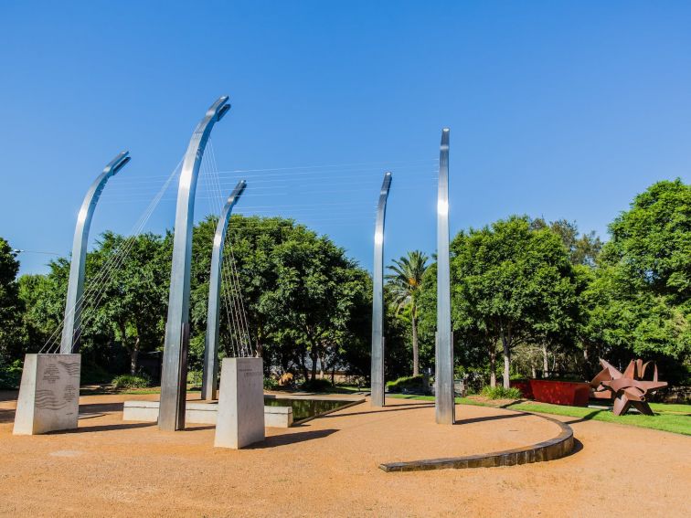 tall silver poles with wires connecting them to each other and concrete pylons