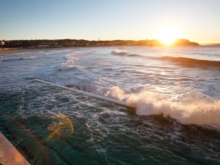 Sunrise at Bondi Beach with Bondi ocean pool in foreground. View from Bondi Icebergs Club