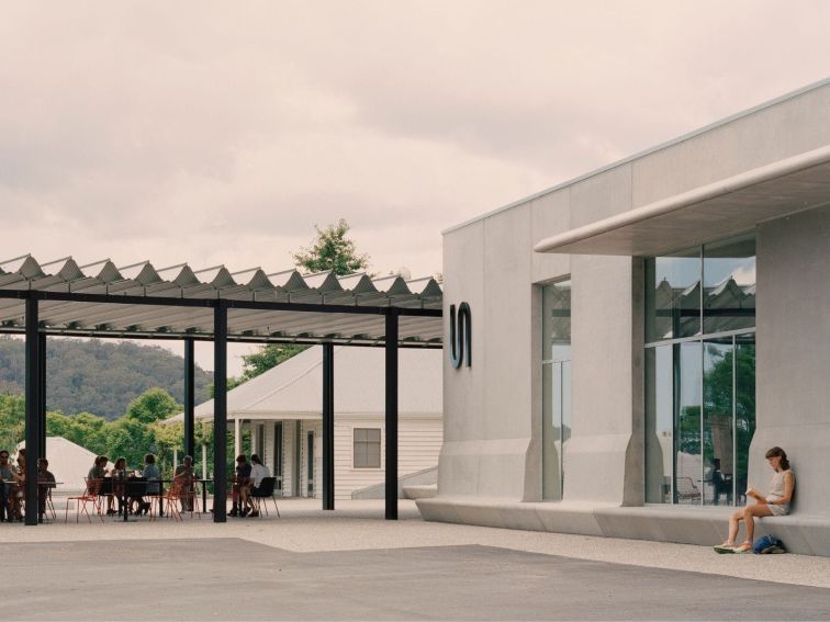 Visitors enjoying themselves in the Ramox Cafe forecourt and in front of the Art Museum concrete fac