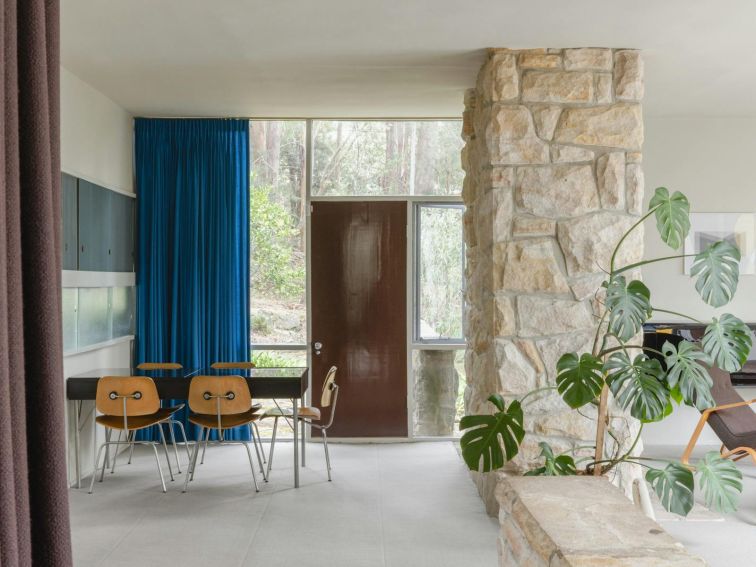 Midcentury living area with stone pillar