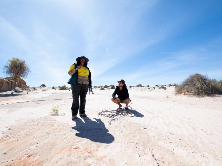 Man learning about the geology of the outback on a guided tour in Mungo National Park