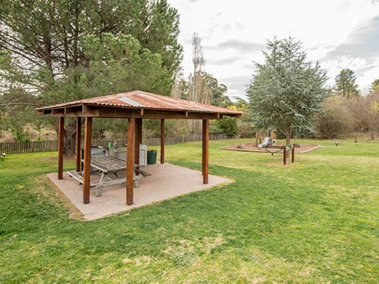 Picnic table and barbecues under shelter at Bill Lyle Reserve picnic area, Hill End Historic Site.