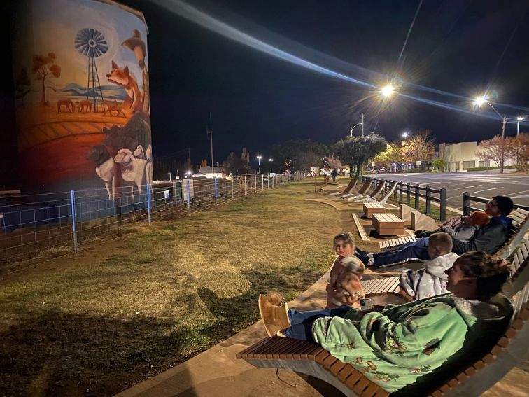 Family sitting in lounge chairs watching light show