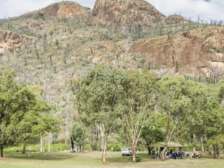 A group enjoying a picnic beside their car at Canyon picnic area, Warrumbungle National Park. Photo: