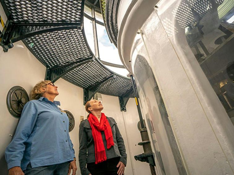 Two women in the tower of Cape Byron Lighthouse, Walgun Cape Byron State Conservation Area. Photo: