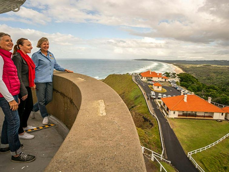 A tour group enjoy views from the top of Cape Byron Lighthouse, Walgun Cape Byron State Conservation