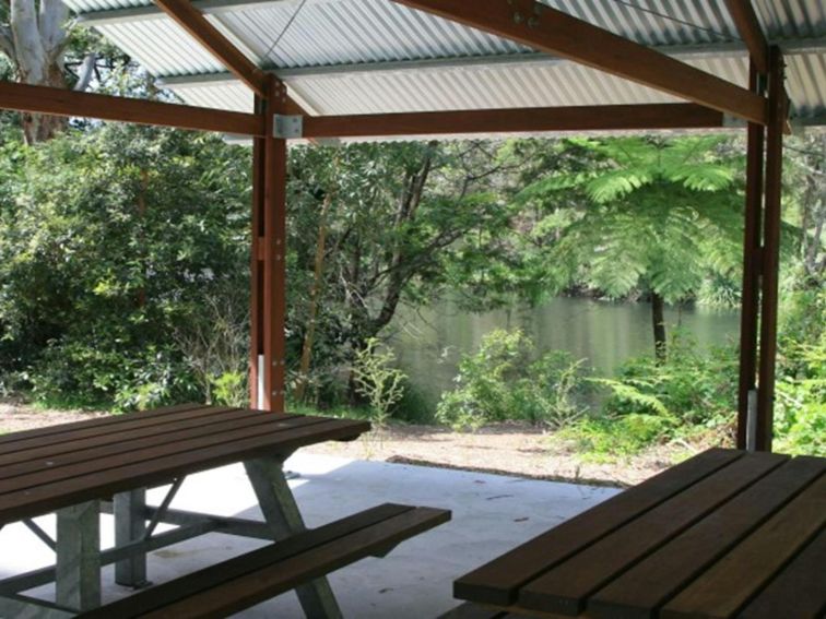 Picnic tables under a shelter at Casuarina Point picnic area in Lane Cove National Park. Photo: