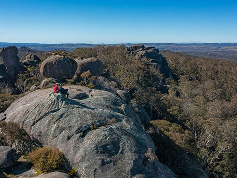 2 hikers sitting at the summit of Cathedral Rock, Cathedral Rock National Park. Photo: Josh Smith