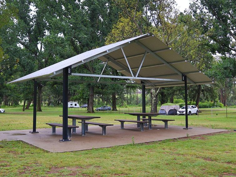 A picnic shed with two picnic tables underneath, at Cattai Farm picnic area in Cattai national Park,