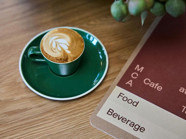 A coffee and menu on a table