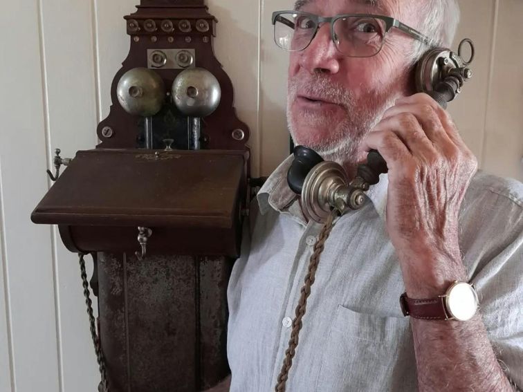 Man using a very old telephone