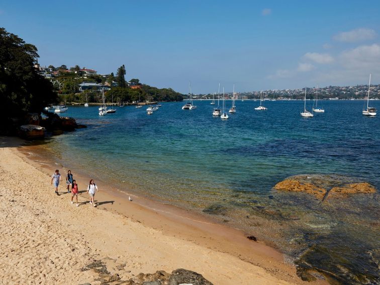 Friends enjoying a walk along Milk Beach on the Hermitage Foreshore Track, Vaucluse in Sydney