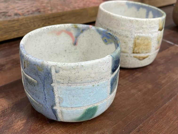 Colourful ceramic bowls on a timber table