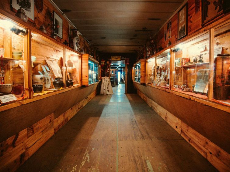 Cabinets lined with interesting gold rush artefacts at History Hill Museum