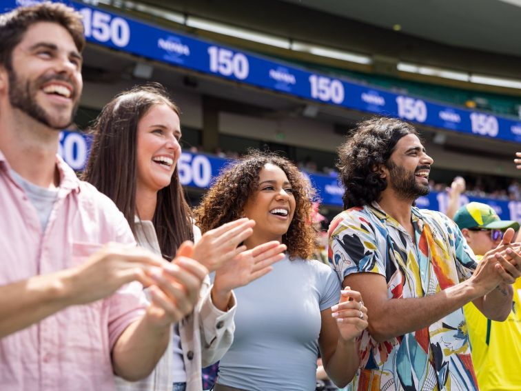 Friends cheering and enjoying a cricket game at the Sydney Cricket Ground