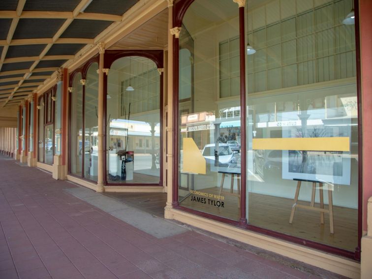 Image of outside artgallery showing sidewalk and glass windows