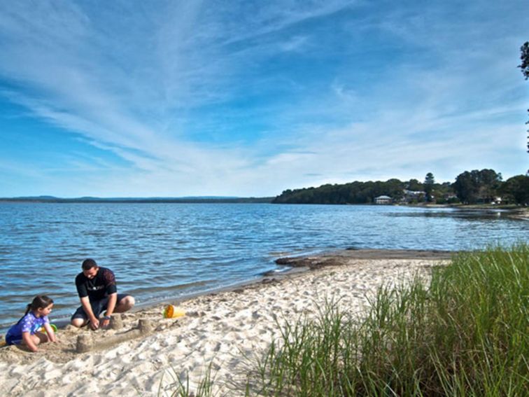 Family playing on the river bank, Elizabeth Bay. Photo: John Spencer &copy; DPIE