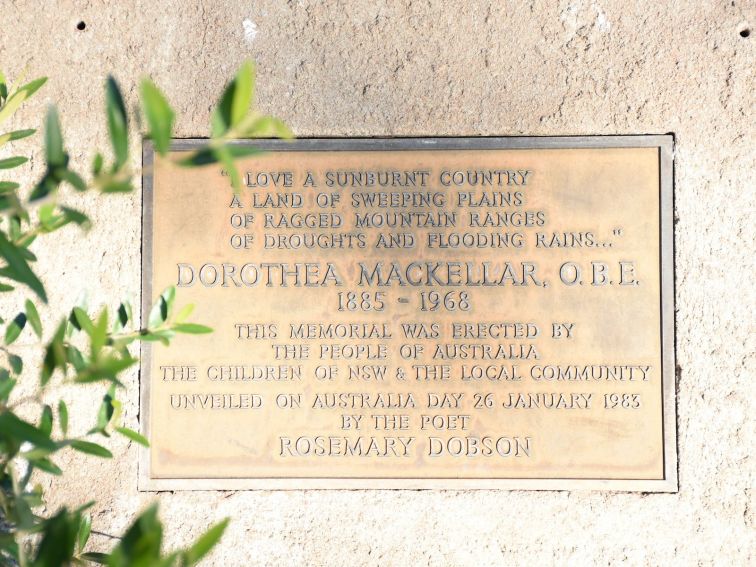 Close-up of the Plaque with some green leaves on left-hand side