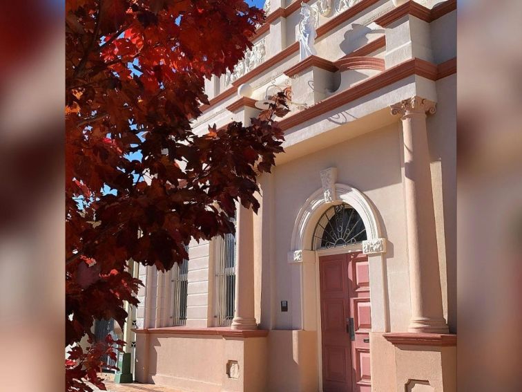 Disused entrance to what was once the School of the Arts Buliding with tree in autum colours on left