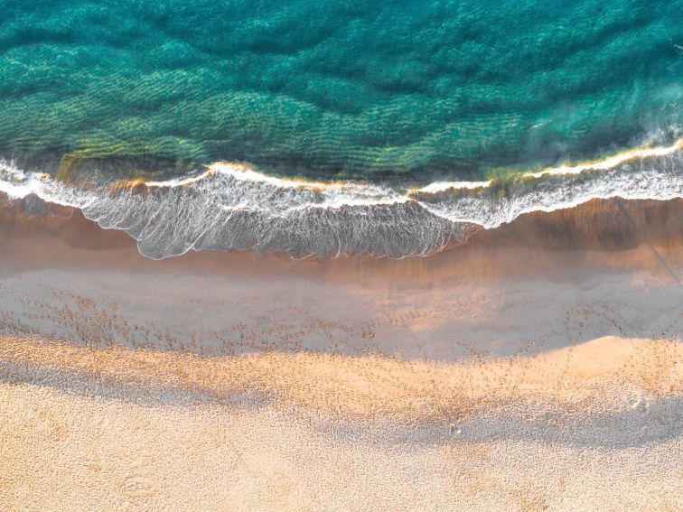 Aerial overlooking footprints along Garie Beach in Sydney's Royal National Park