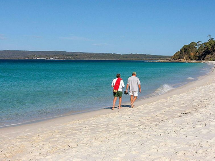 Two men walk along Hyams Beach, Jervis Bay National Park. Photo: Michael Van Ewijk &copy; DPIE