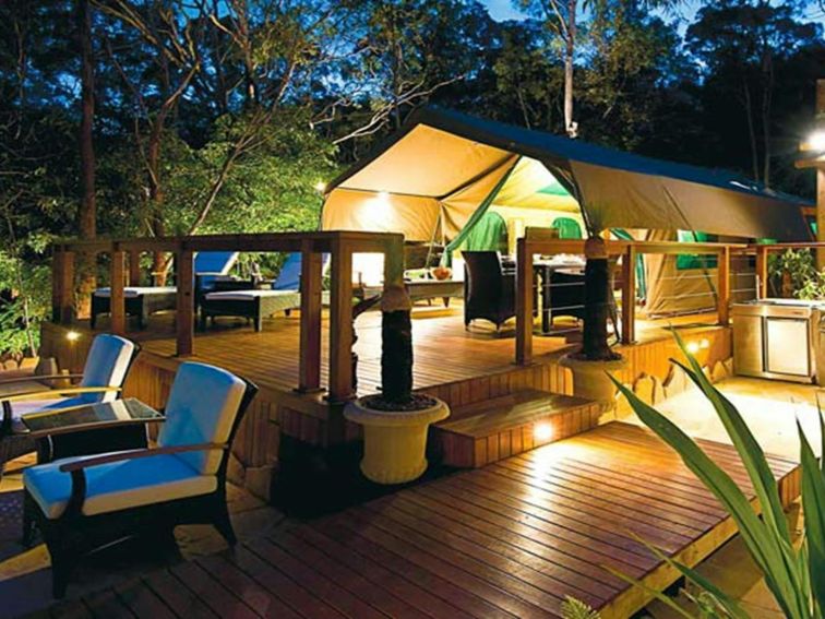 Views of a luxurious tent at Lane Cove Holiday Park - Tandara, lit up at night. Photo: OEH