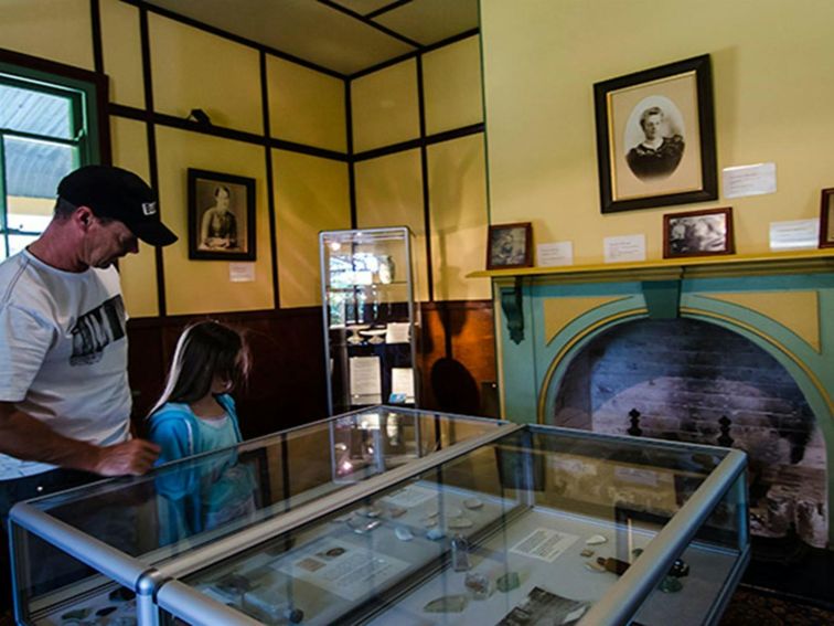 Visitors look at artefacts in a glass cabinet in Roto House, Roto House Historic Site. Photo: John