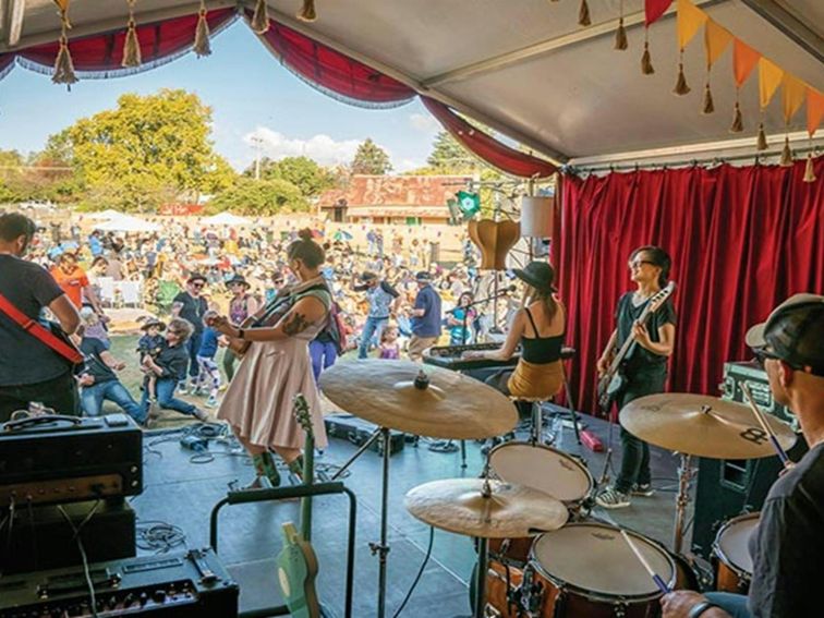 A band performing on stage in front of a crowd at The End Festival in Hill End Historic Site. Photo: