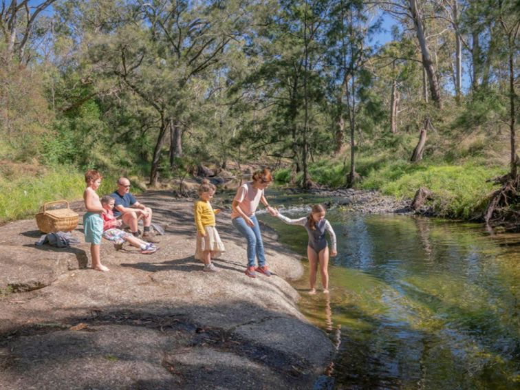 A family enjoying the Washpools waterhole along the Middle Brook.  Credit: John Spencer &copy; DPE