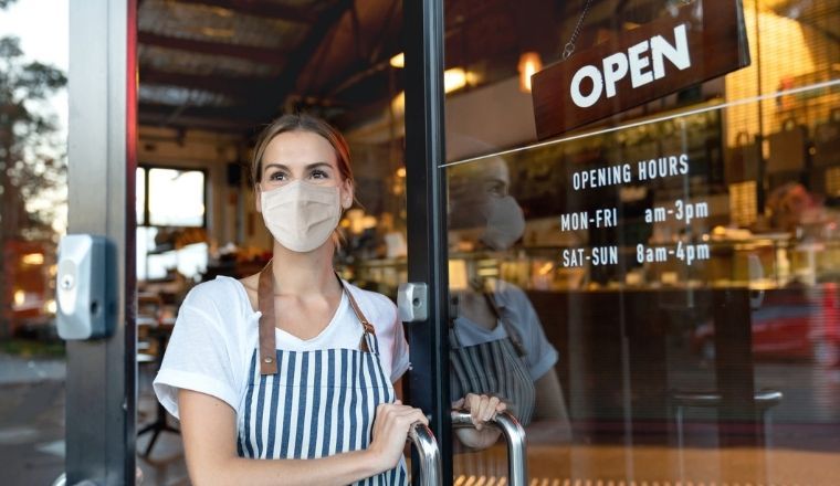 A cafe worker wearing a mask