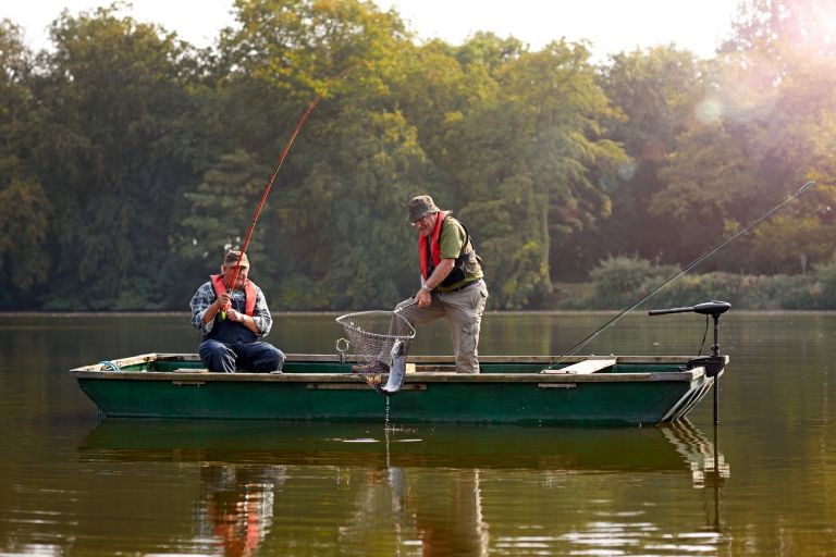 Safe boating with two men wearing safety jackets