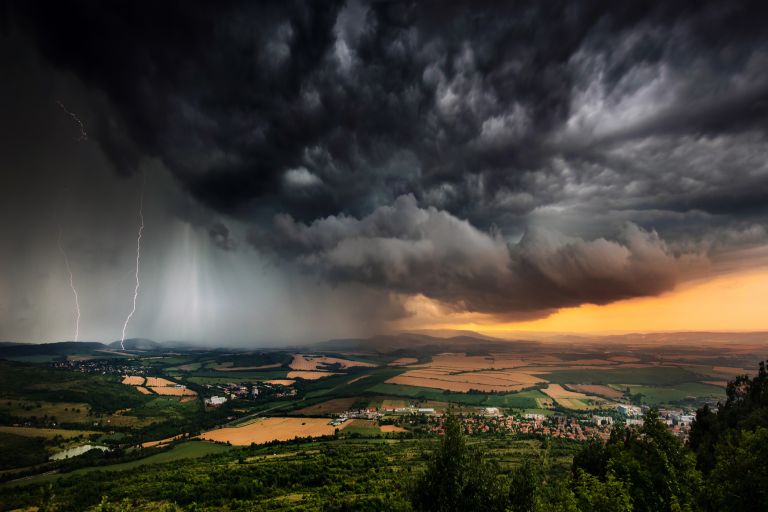 Landscape with dark storm clouds and flashes