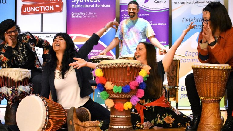 Staff and community members enjoying a drumming performance