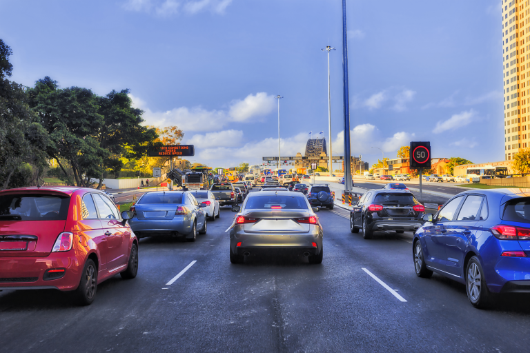 Cars sitting in traffic on busy road