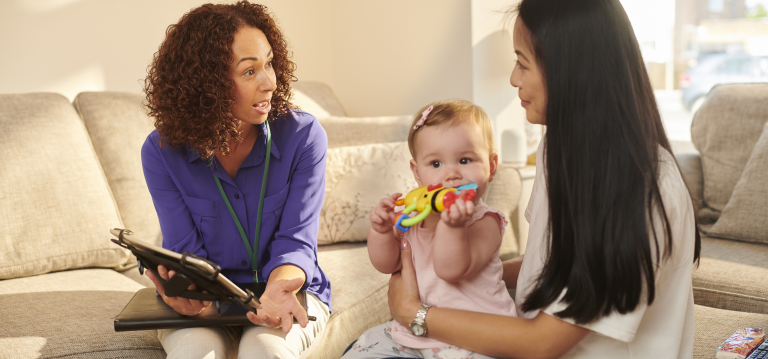 Support worker talking to young mother