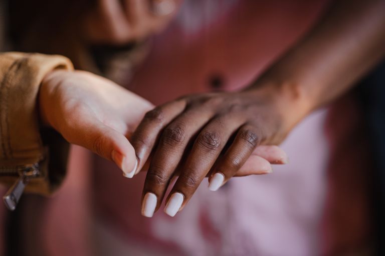 Image of two people hand in hand