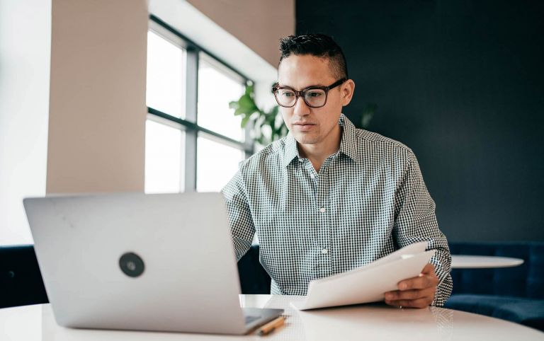 Man sitting in front of a laptop