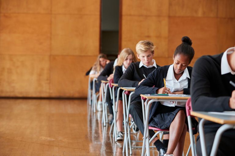 Students at desks doing a written exam