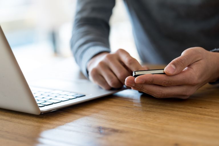 Man with laptop and phone