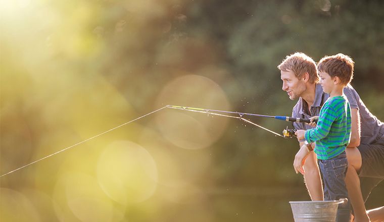 Image of an older man fishing with a young boy