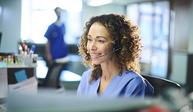 Nurse in hospital with headset smiling