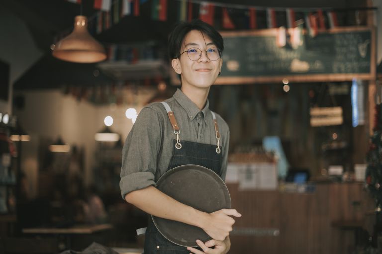 Young man working in a cafe